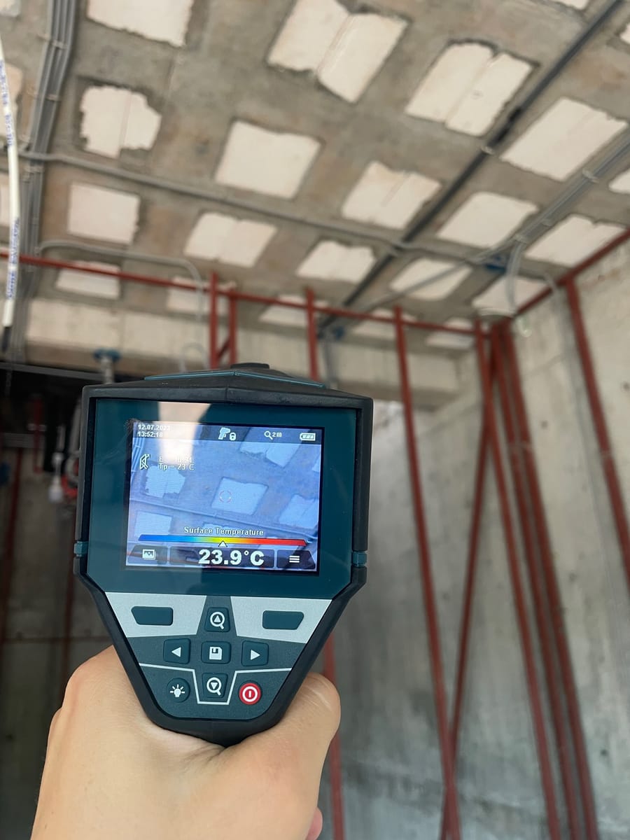 A handheld thermal imaging camera displaying a surface temperature reading of 23.9 degrees Celsius.